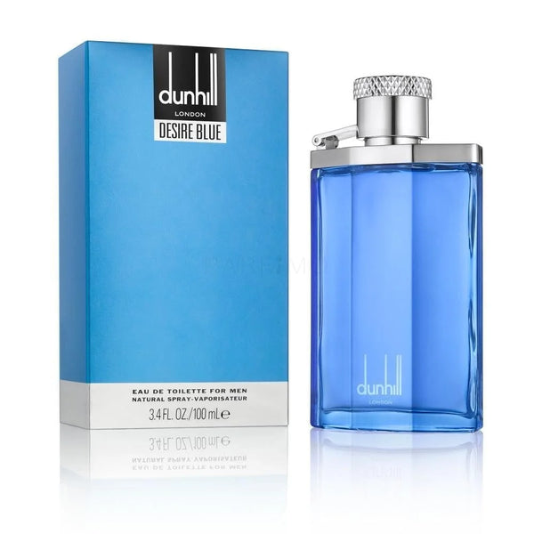 Botella de perfume rectangular de vidrio azul brillante "Desire Blue" de Dunhill London de 100 ml con tapón metálico plateado estilo petaca y bisagra, junto a su caja azul turquesa con un rectángulo negro central que contiene el logotipo de la marca.