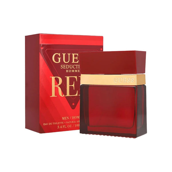Botella de perfume rectangular en vidrio rojo intenso "Guess Seductive Homme Red" de 100 ml con una banda dorada en el cuello grabado con la marca y tapón rojo, junto a su caja roja con letras doradas y el icónico triángulo de Guess en el frente.
